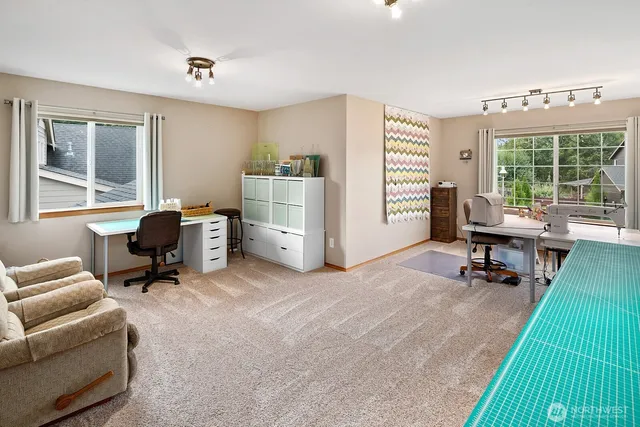 a view of a livingroom with workspace and a window