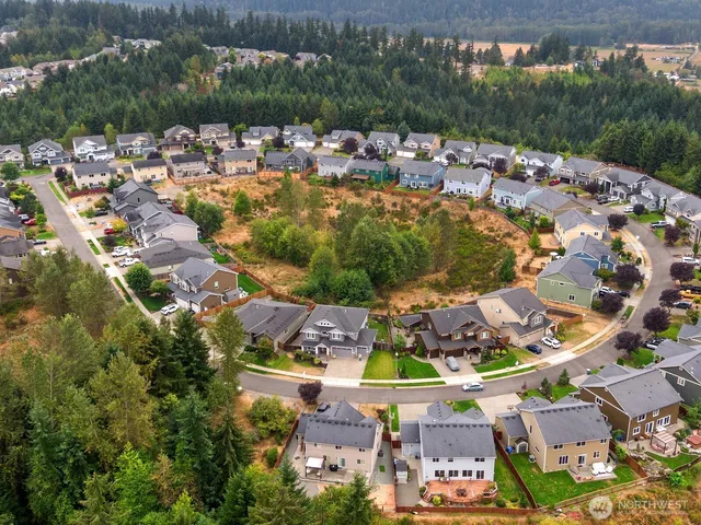 an aerial view of multiple houses with a swimming pool
