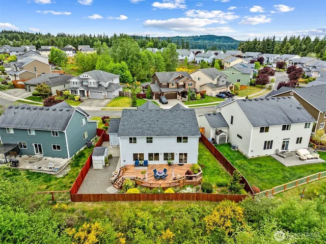 a view of a house with backyard sitting area and garden