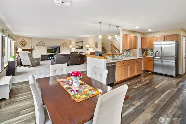 a large white kitchen with lots of counter top space and stainless steel appliances