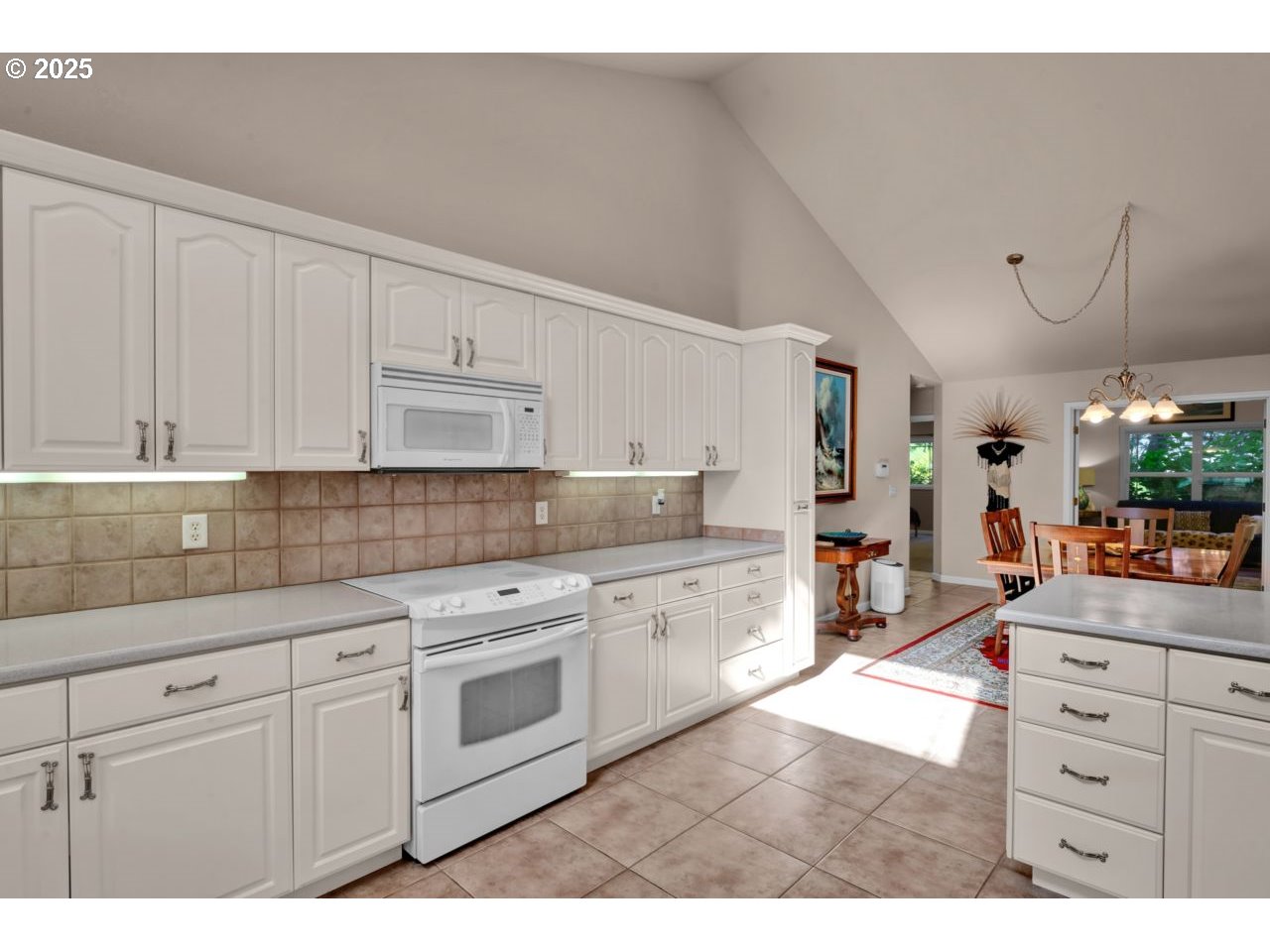 2131 Willow Loop Florence, OR 97439 - Photo 19 of 48 a kitchen with cabinets wooden floor and white appliances