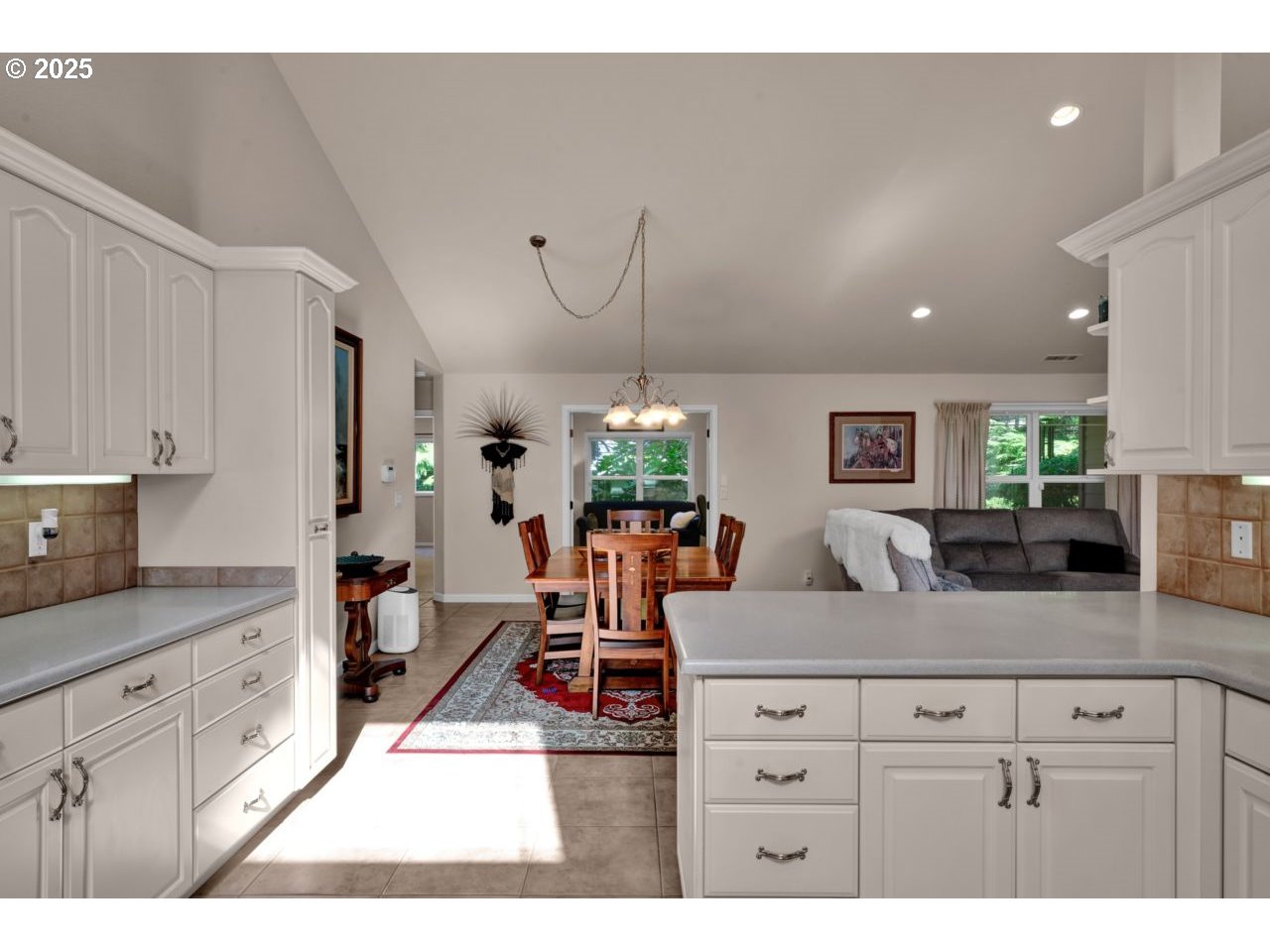 2131 Willow Loop Florence, OR 97439 - Photo 20 of 48 a living room with stainless steel appliances kitchen island granite countertop a sink a stove a dining table and chairs