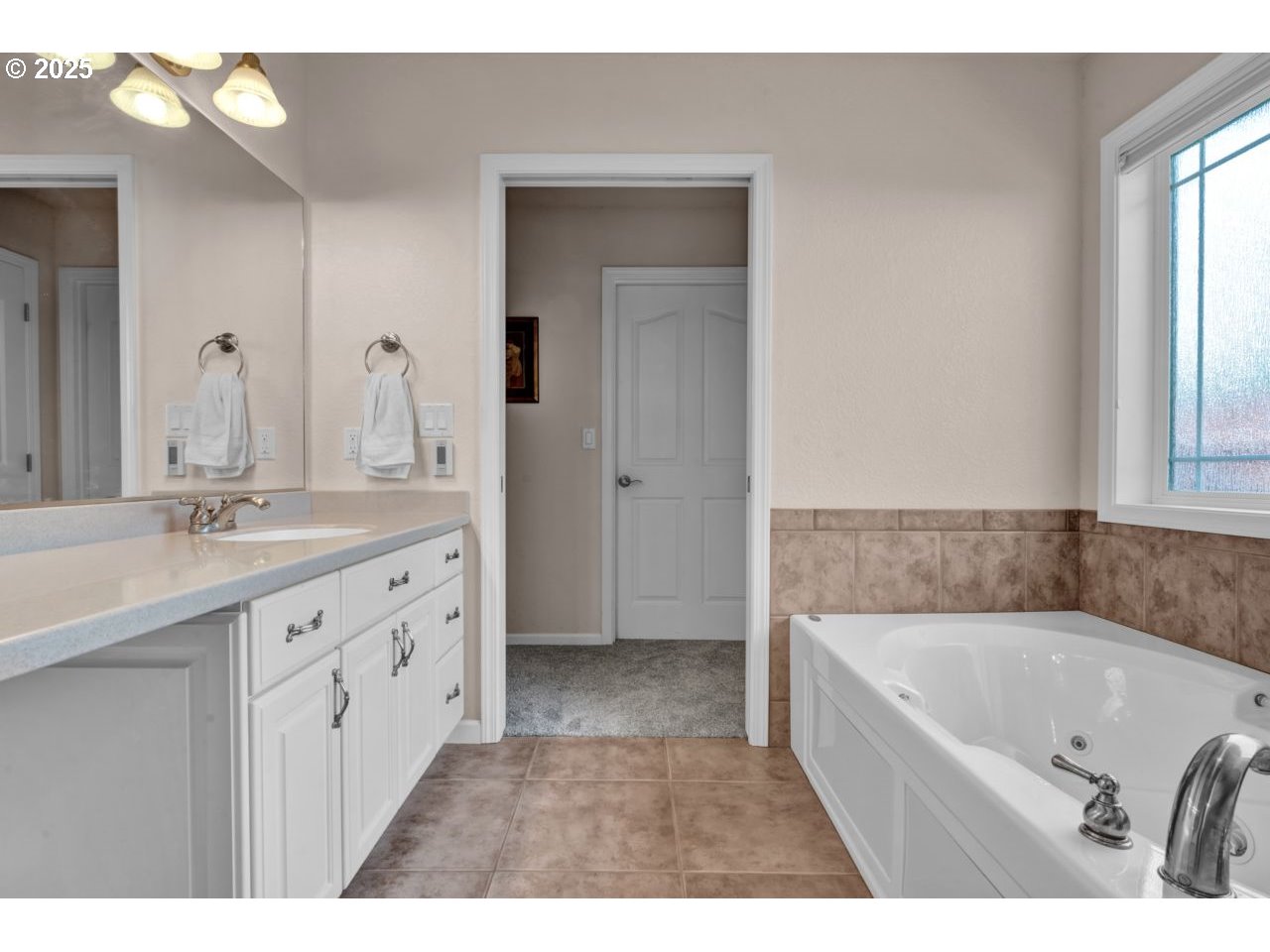 2131 Willow Loop Florence, OR 97439 - Photo 29 of 48 a bathroom with a granite countertop tub sink and mirror