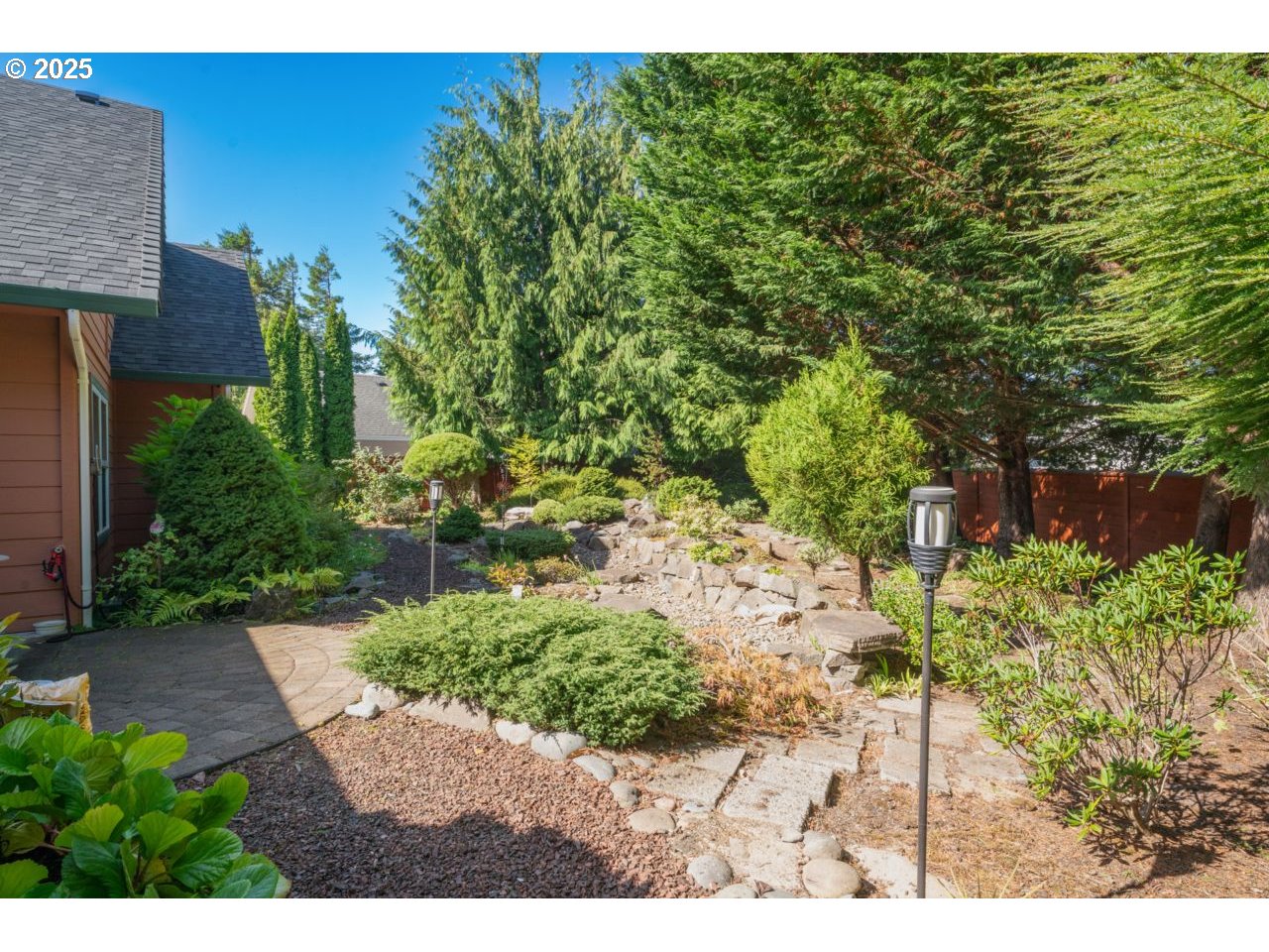 2131 Willow Loop Florence, OR 97439 - Photo 5 of 48 a view of backyard with plants and outdoor seating