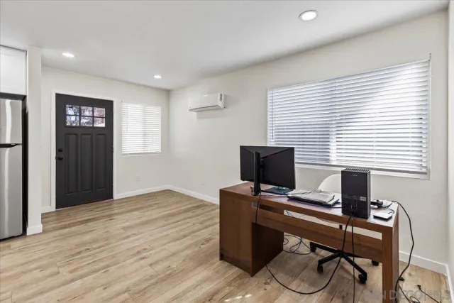 a kitchen with a refrigerator a sink and wooden cabinets