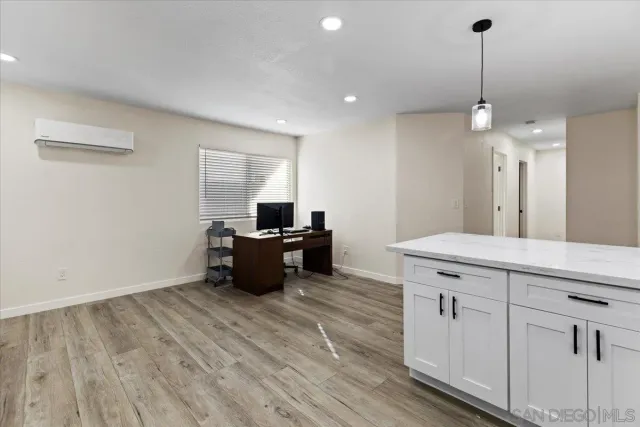 a kitchen with kitchen island white cabinets and counter space