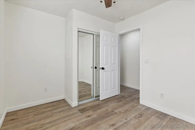 a bathroom with a granite countertop sink mirror vanity and toilet