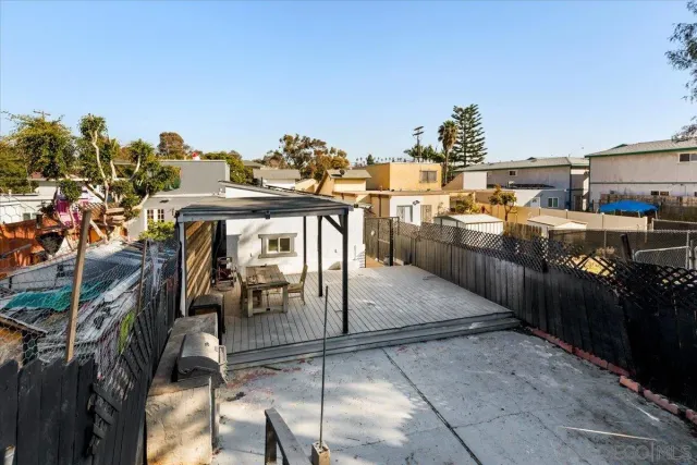 a view of balcony with wooden floor and fence