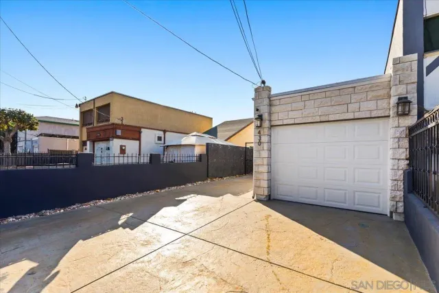 a kitchen with kitchen island granite countertop a sink a stove a refrigerator and white cabinets