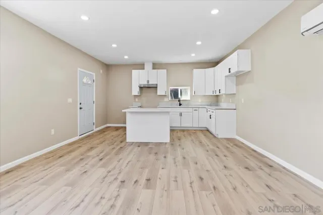 a bathroom with a double vanity sink a mirror and a shower