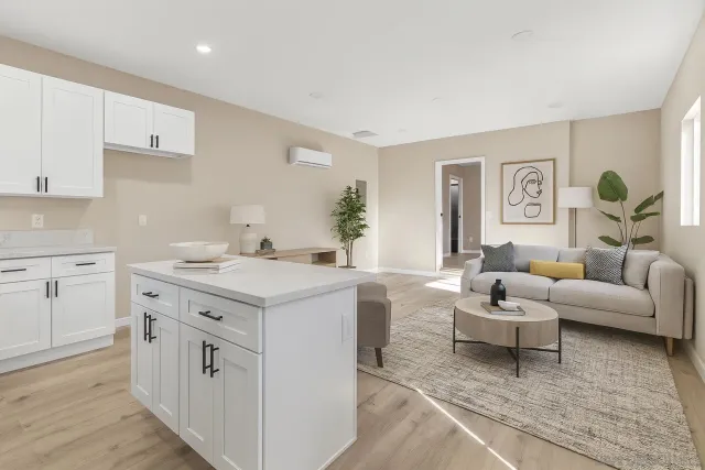 a living room with kitchen island furniture and a wooden floor