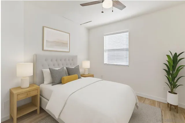 a bedroom with a bed and a potted plant