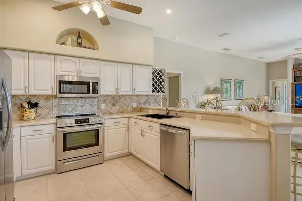 a kitchen with cabinets stainless steel appliances and a counter space