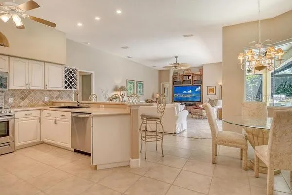 a kitchen with cabinets and chairs