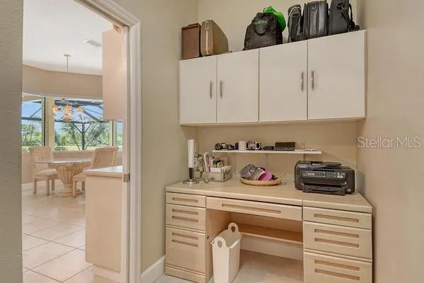 a kitchen with white cabinets and a stove with wooden floor