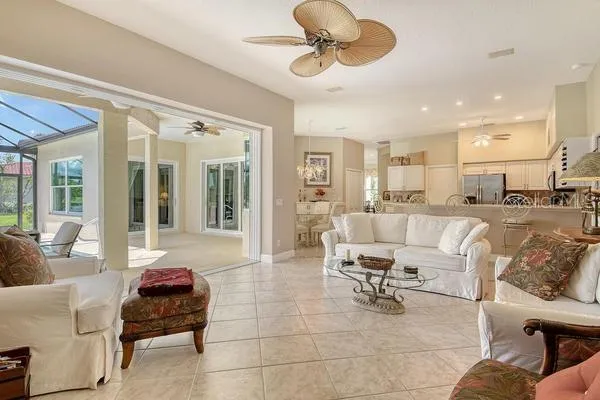 a living room with furniture and a dining table with kitchen view