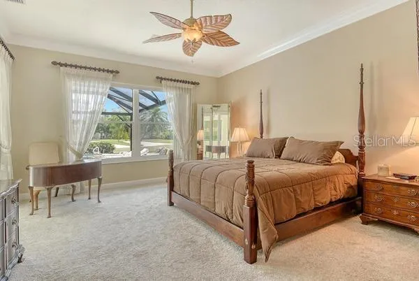 a bedroom with a bed and a chandelier