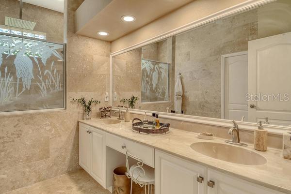 9477 Cedar Ridge Lane Sarasota, FL 34238 - Photo 21 of 51 a bathroom with double sink and a mirror