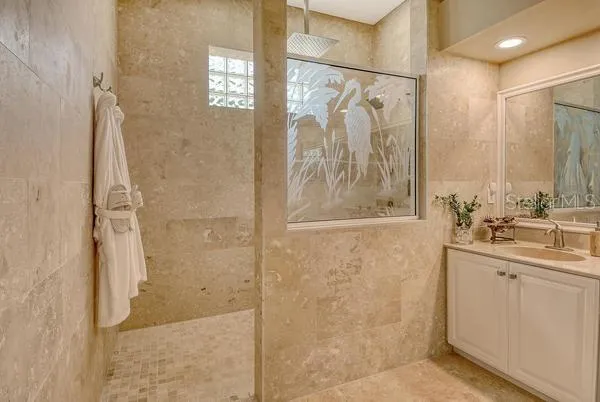 a bathroom with a shower sink and mirror