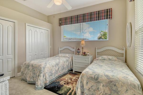9477 Cedar Ridge Lane Sarasota, FL 34238 - Photo 28 of 51 a bedroom with two beds and a window