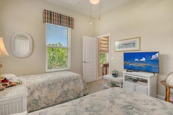 a living room with furniture a flat screen tv and a window