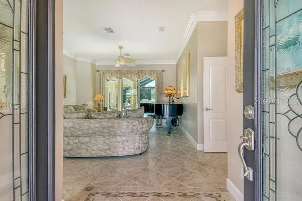 a living room with furniture and a chandelier