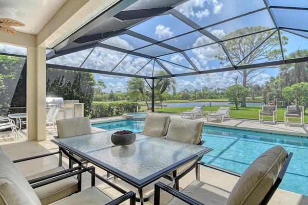 9477 Cedar Ridge Lane Sarasota, FL 34238 - Photo 31 of 51 a view of a patio with a table chairs and a table