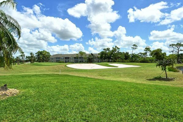9477 Cedar Ridge Lane Sarasota, FL 34238 - Photo 36 of 51 a view of a golf course with a big yard