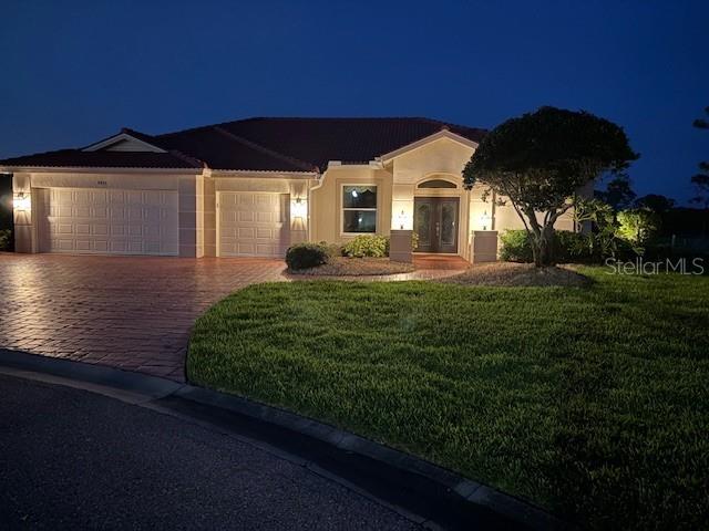 9477 Cedar Ridge Lane Sarasota, FL 34238 - Photo 37 of 51 a front view of a house with a garden