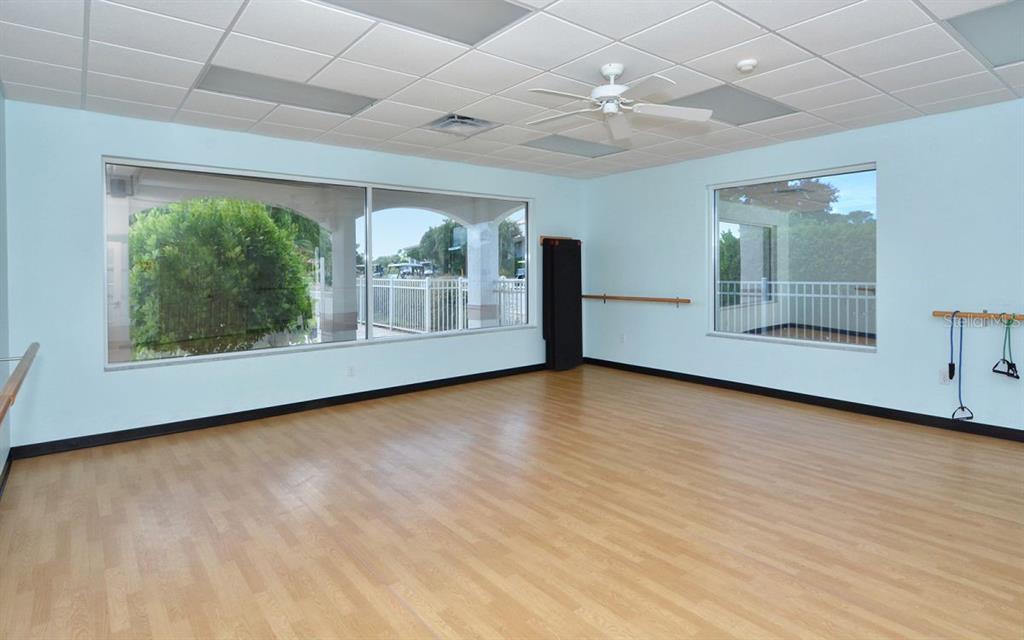 9477 Cedar Ridge Lane Sarasota, FL 34238 - Photo 46 of 51 an empty room with wooden floor and windows