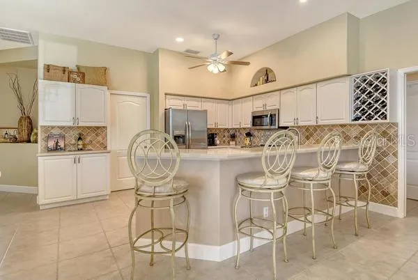 a kitchen with cabinets and chairs