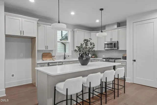 a bedroom with a large bed and a ceiling fan