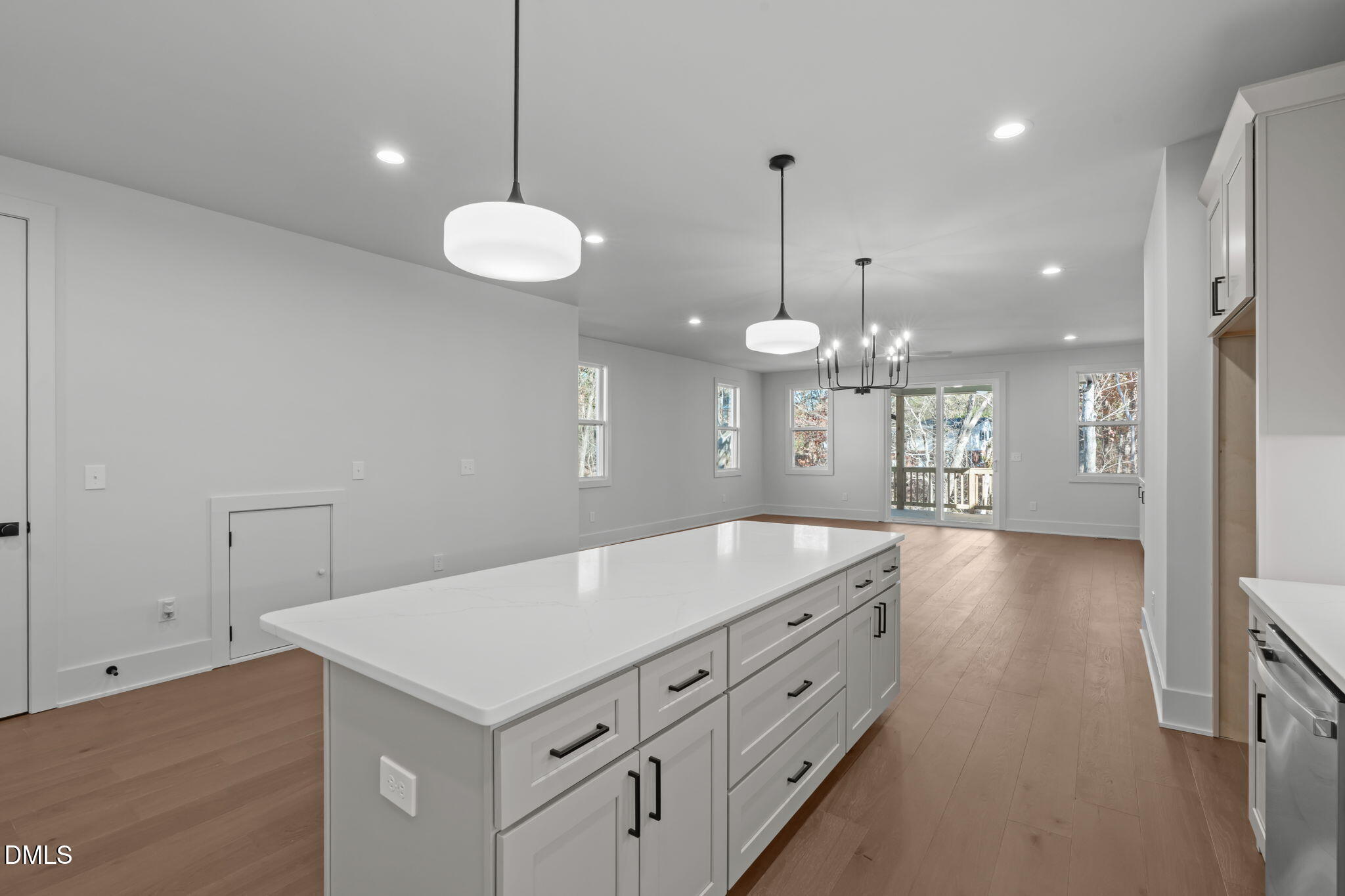 635 Conover Road, Unit A Durham, NC 27703 - Photo 14 of 48 a kitchen with a stove chandelier and wooden floor