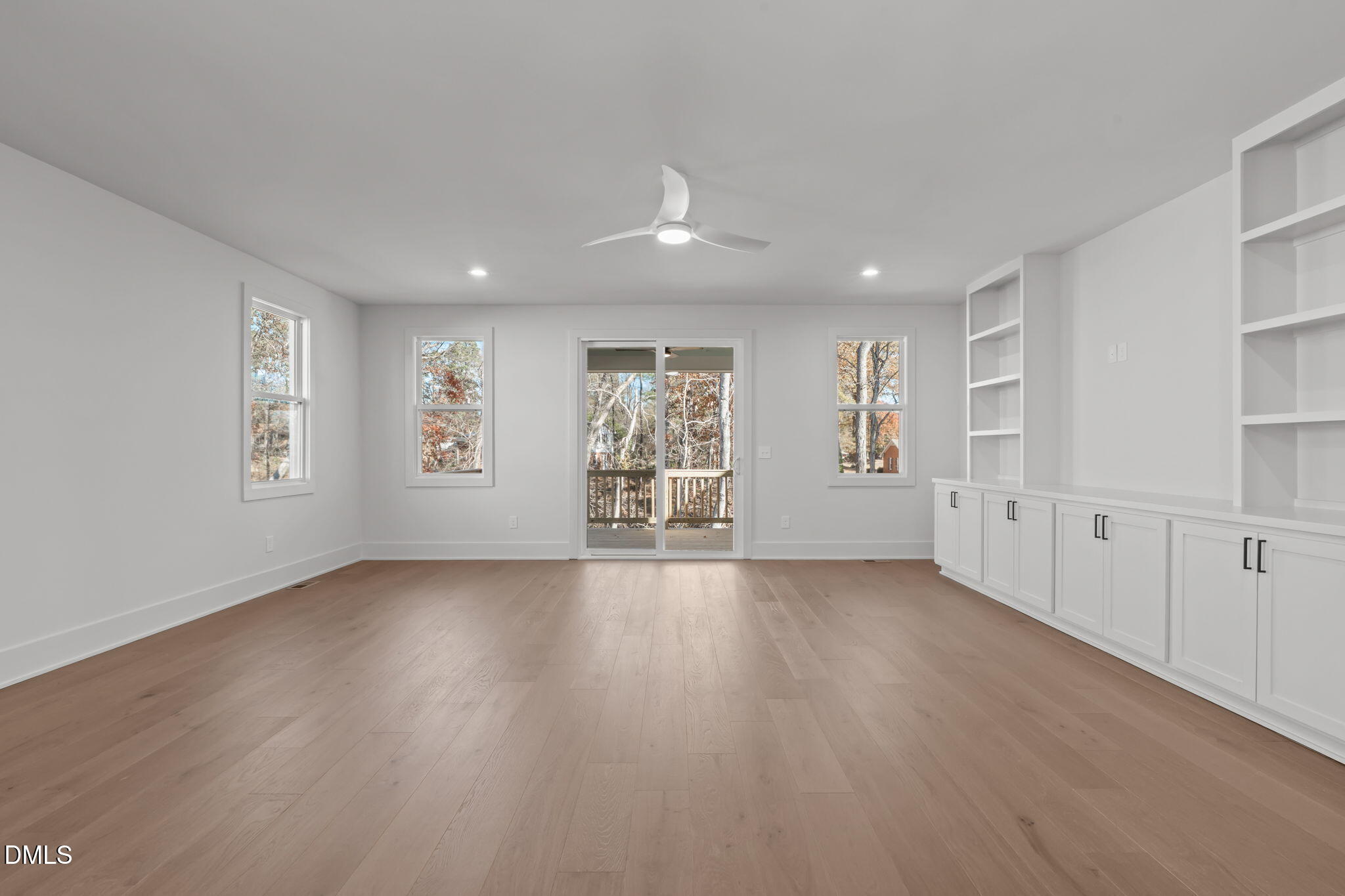 635 Conover Road, Unit A Durham, NC 27703 - Photo 18 of 48 a view of an empty room with a window and wooden floor