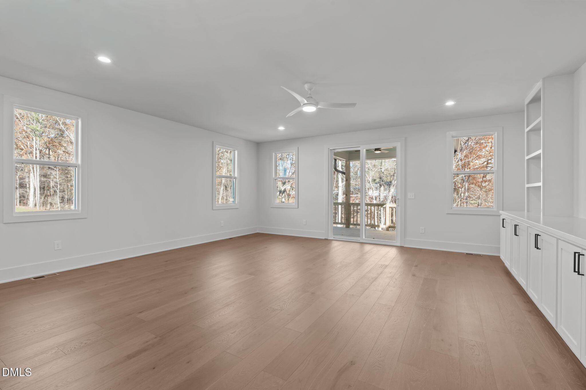 635 Conover Road, Unit A Durham, NC 27703 - Photo 19 of 48 a view of an empty room with wooden floor and fan