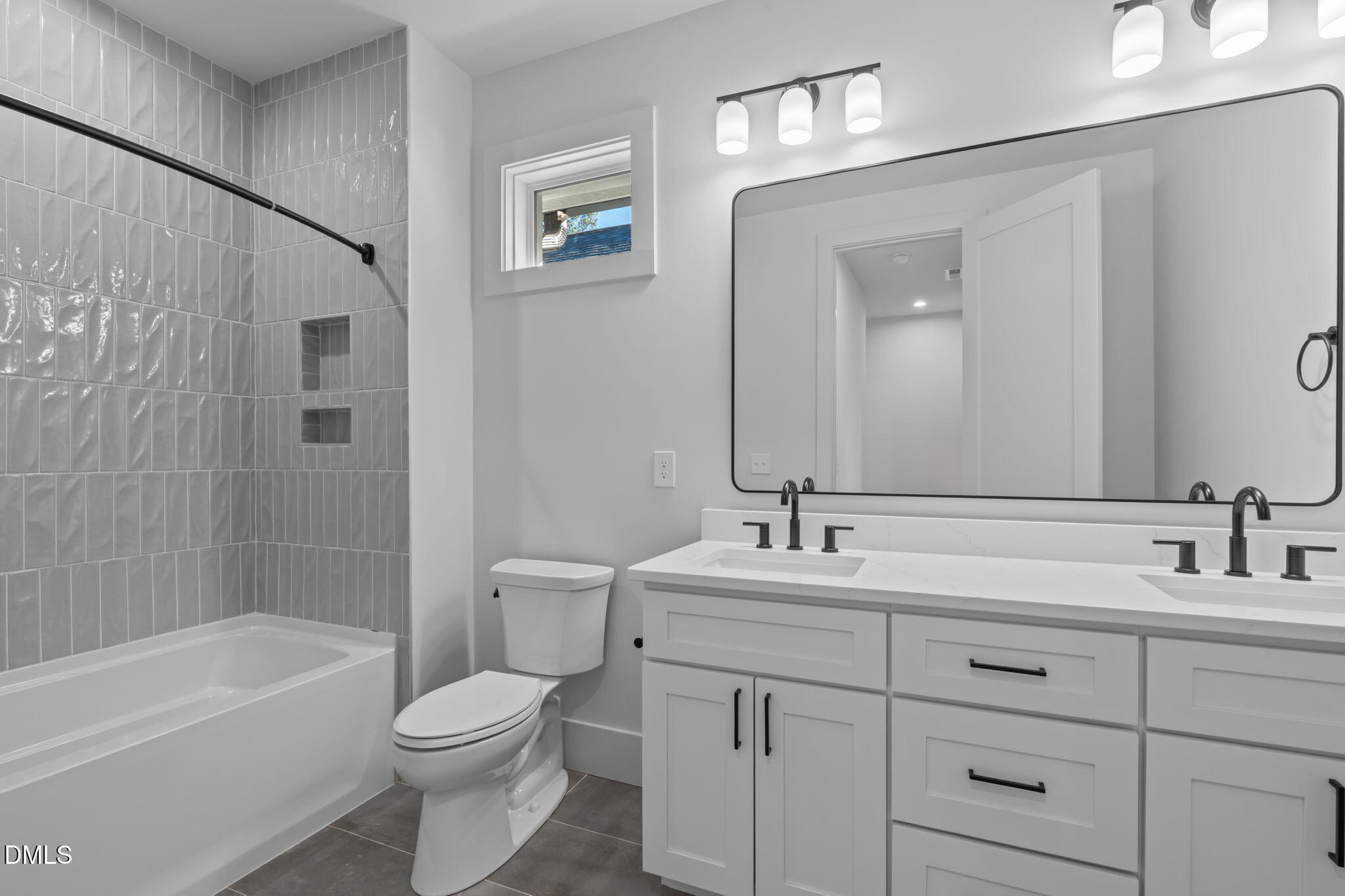 635 Conover Road, Unit A Durham, NC 27703 - Photo 37 of 48 a bathroom with a toilet a sink a bathtub and a mirror