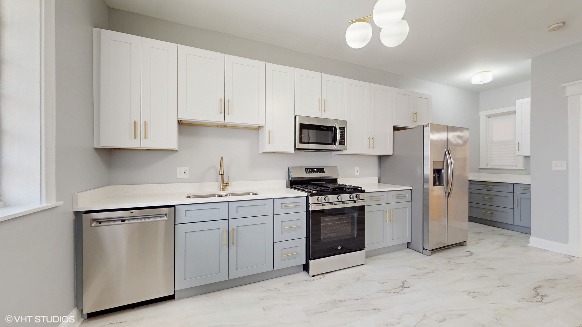 5237 South Michigan Avenue, Unit 1N Chicago, IL 60615 - Photo 16 of 47 a kitchen with stainless steel appliances granite countertop white cabinets a sink a stove a refrigerator and a microwave