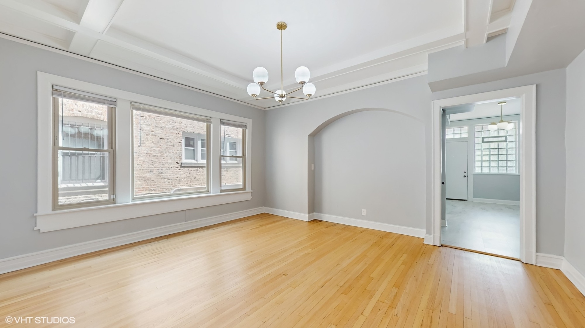 5237 South Michigan Avenue, Unit 1N Chicago, IL 60615 - Photo 19 of 47 a view of an empty room with a window and wooden floor