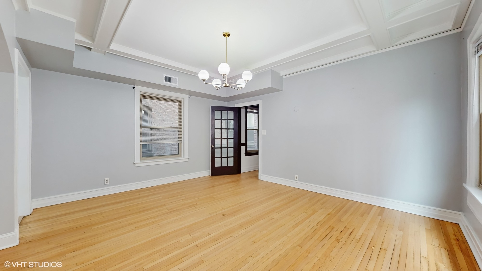 5237 South Michigan Avenue, Unit 1N Chicago, IL 60615 - Photo 23 of 47 a view of an empty room with wooden floor and a window