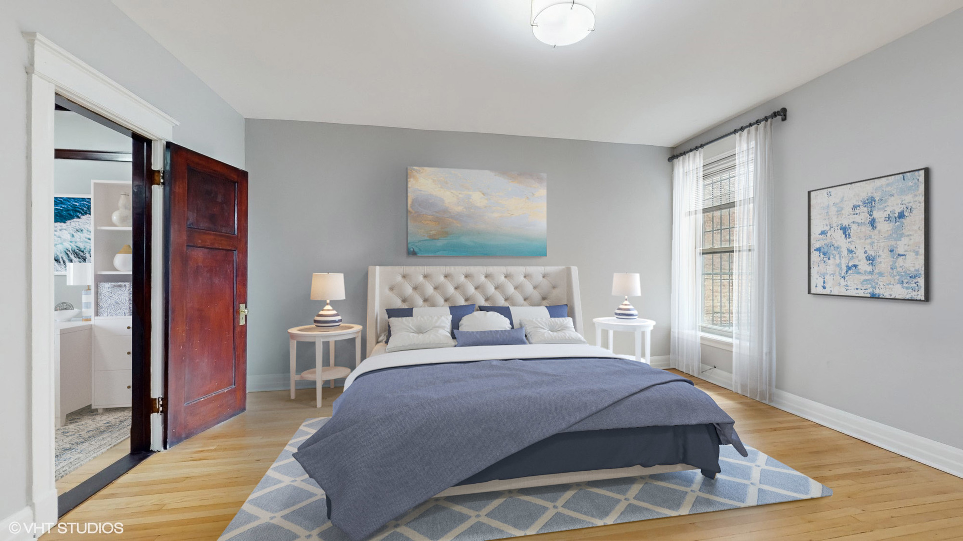 5237 South Michigan Avenue, Unit 1N Chicago, IL 60615 - Photo 24 of 47 a bedroom with a large bed and a chandelier