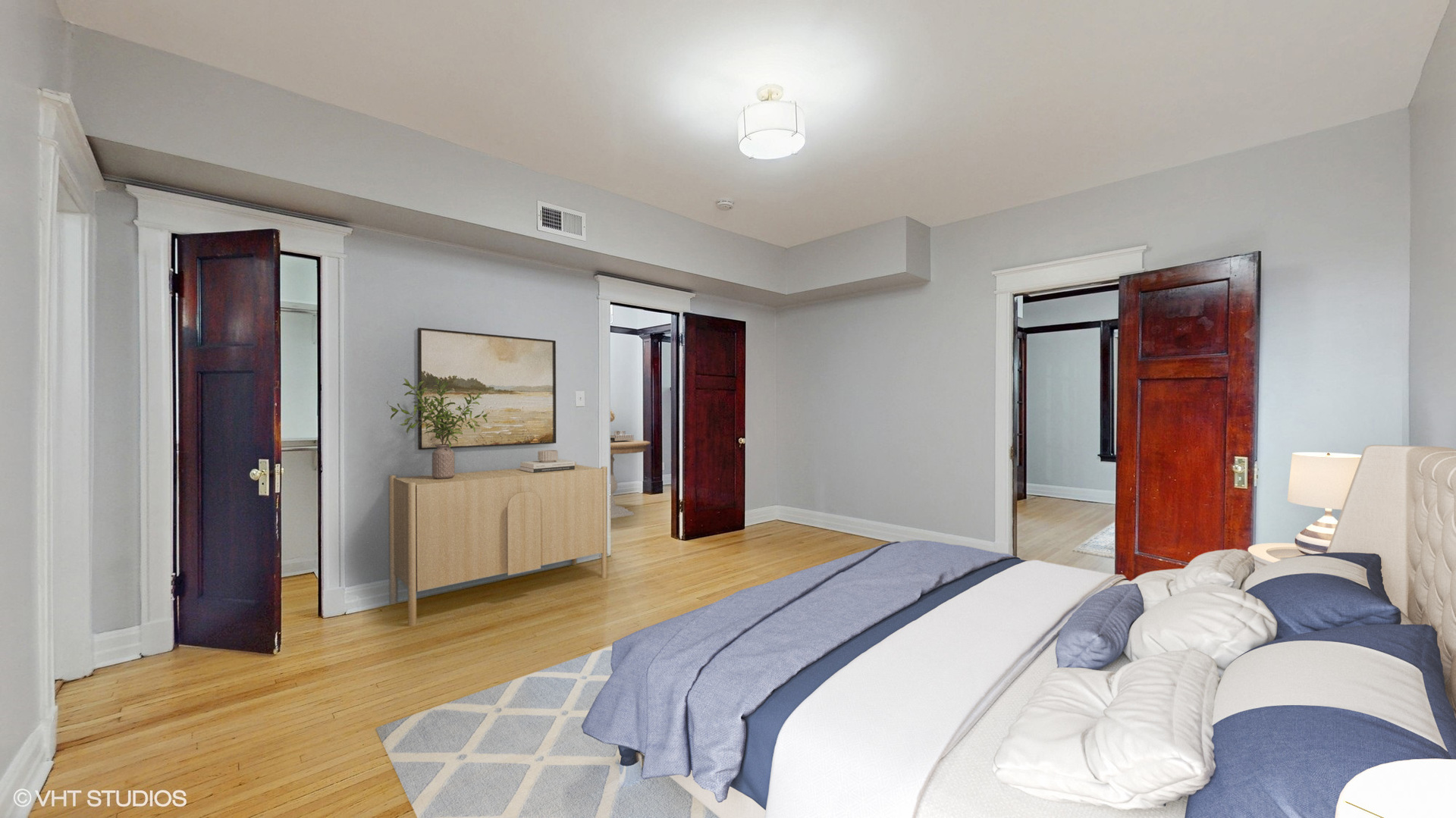 5237 South Michigan Avenue, Unit 1N Chicago, IL 60615 - Photo 26 of 47 a bedroom with a large bed and a chandelier