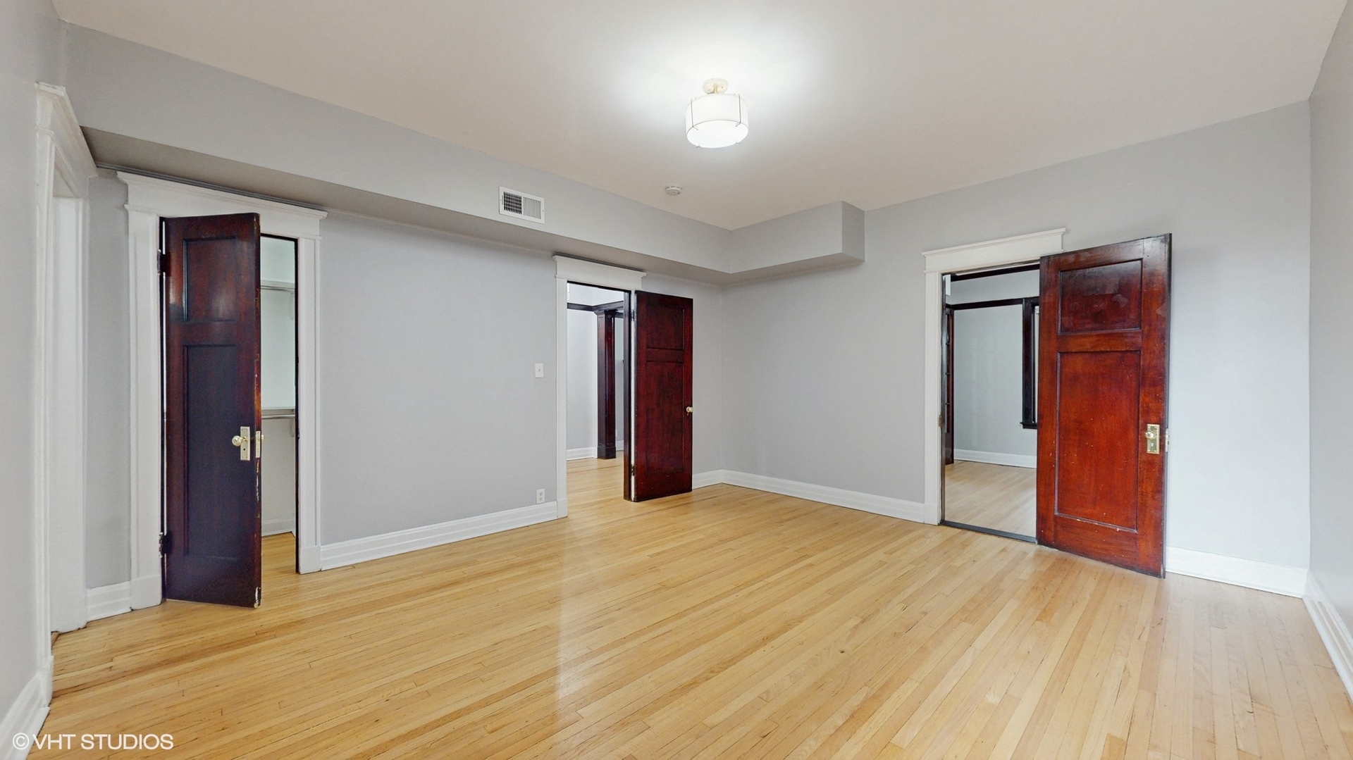 5237 South Michigan Avenue, Unit 1N Chicago, IL 60615 - Photo 27 of 47 a view of an empty room with wooden floor and closet