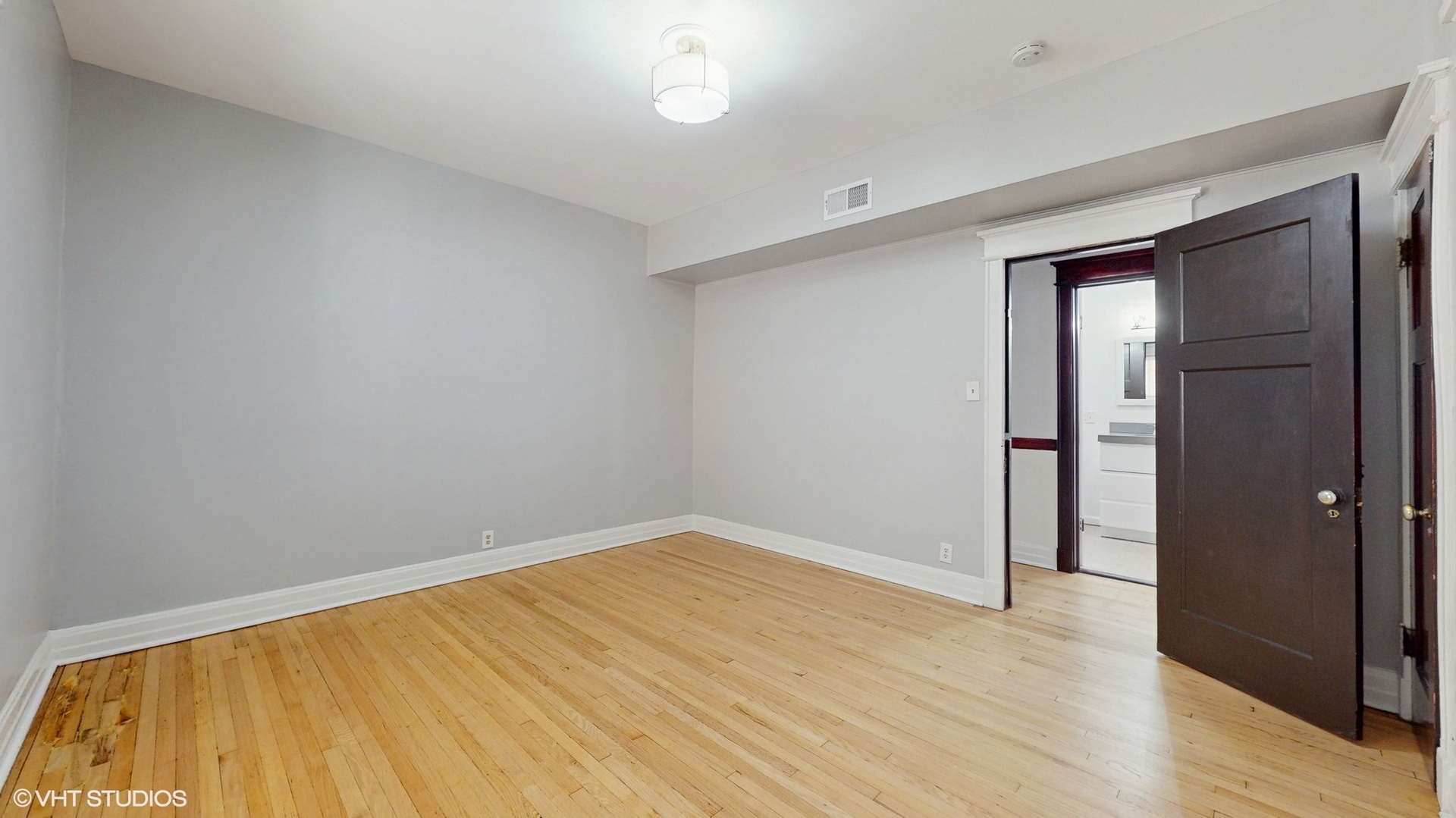 5237 South Michigan Avenue, Unit 1N Chicago, IL 60615 - Photo 33 of 47 wooden floor in an empty room