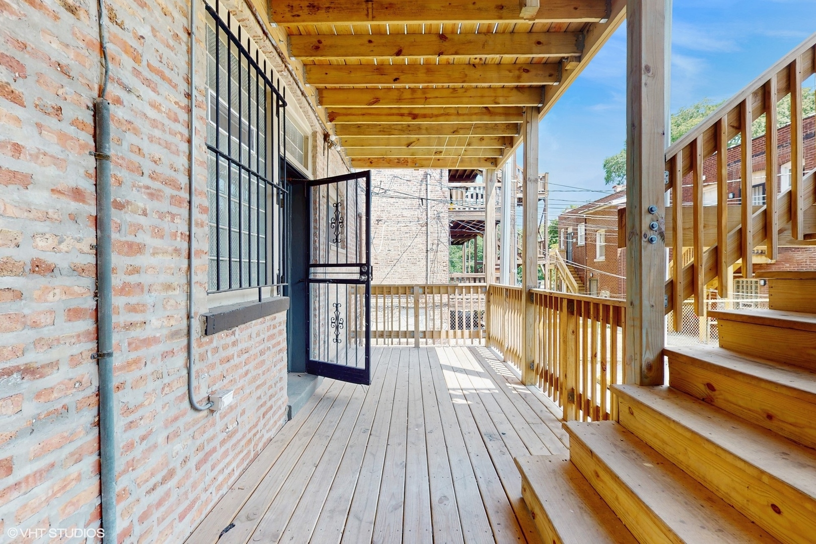 5237 South Michigan Avenue, Unit 1N Chicago, IL 60615 - Photo 42 of 47 a view of a balcony with wooden floor and iron stairs