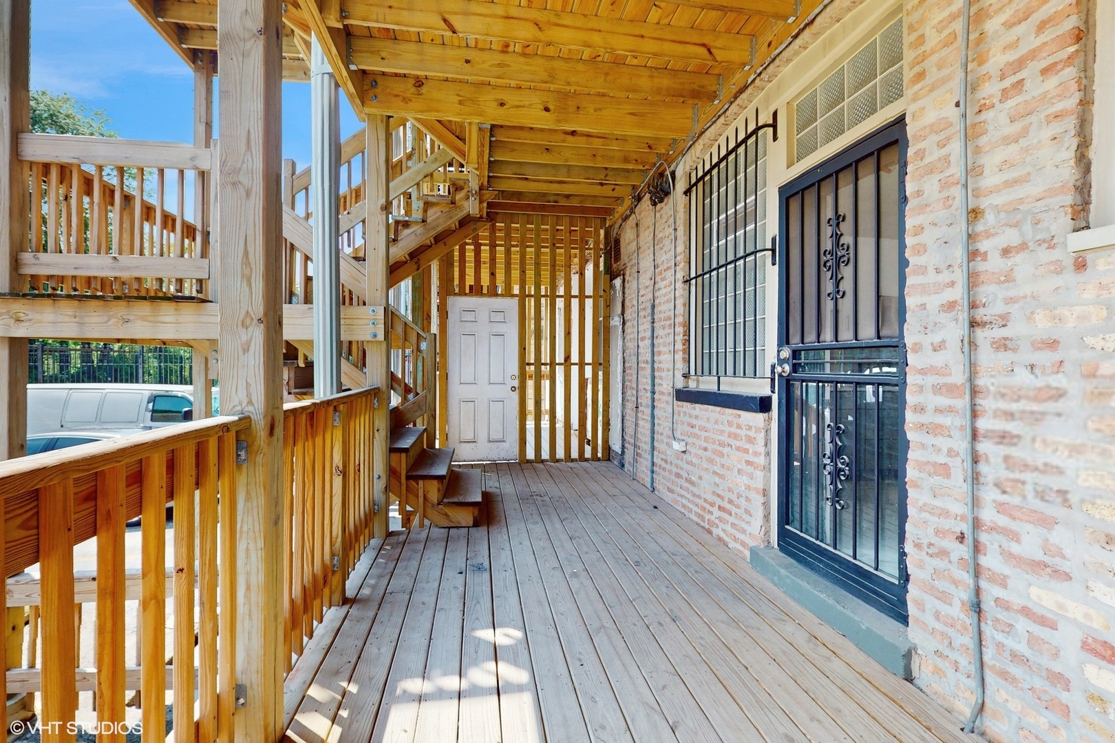 5237 South Michigan Avenue, Unit 1N Chicago, IL 60615 - Photo 44 of 47 a view of a balcony with wooden floor and iron stairs