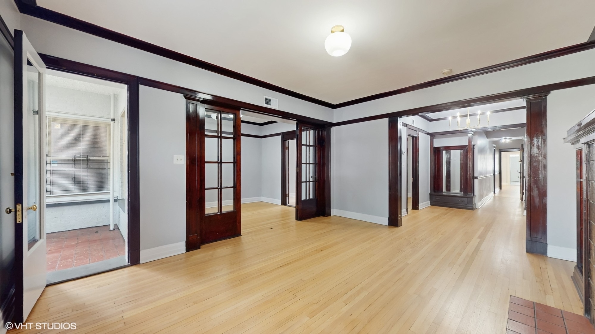 5237 South Michigan Avenue, Unit 1N Chicago, IL 60615 - Photo 6 of 47 a view of empty room with wooden floor and windows