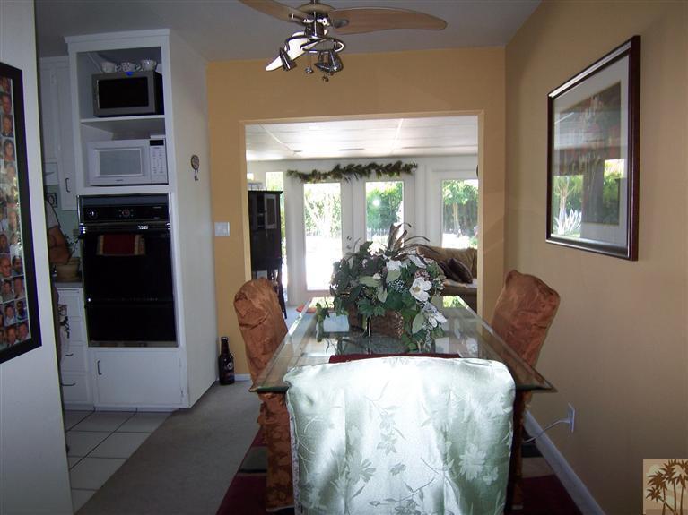 70170 Chappel Road Rancho Mirage, CA 92270 - Photo 3 of 14 a view of a dining room with furniture and chandelier