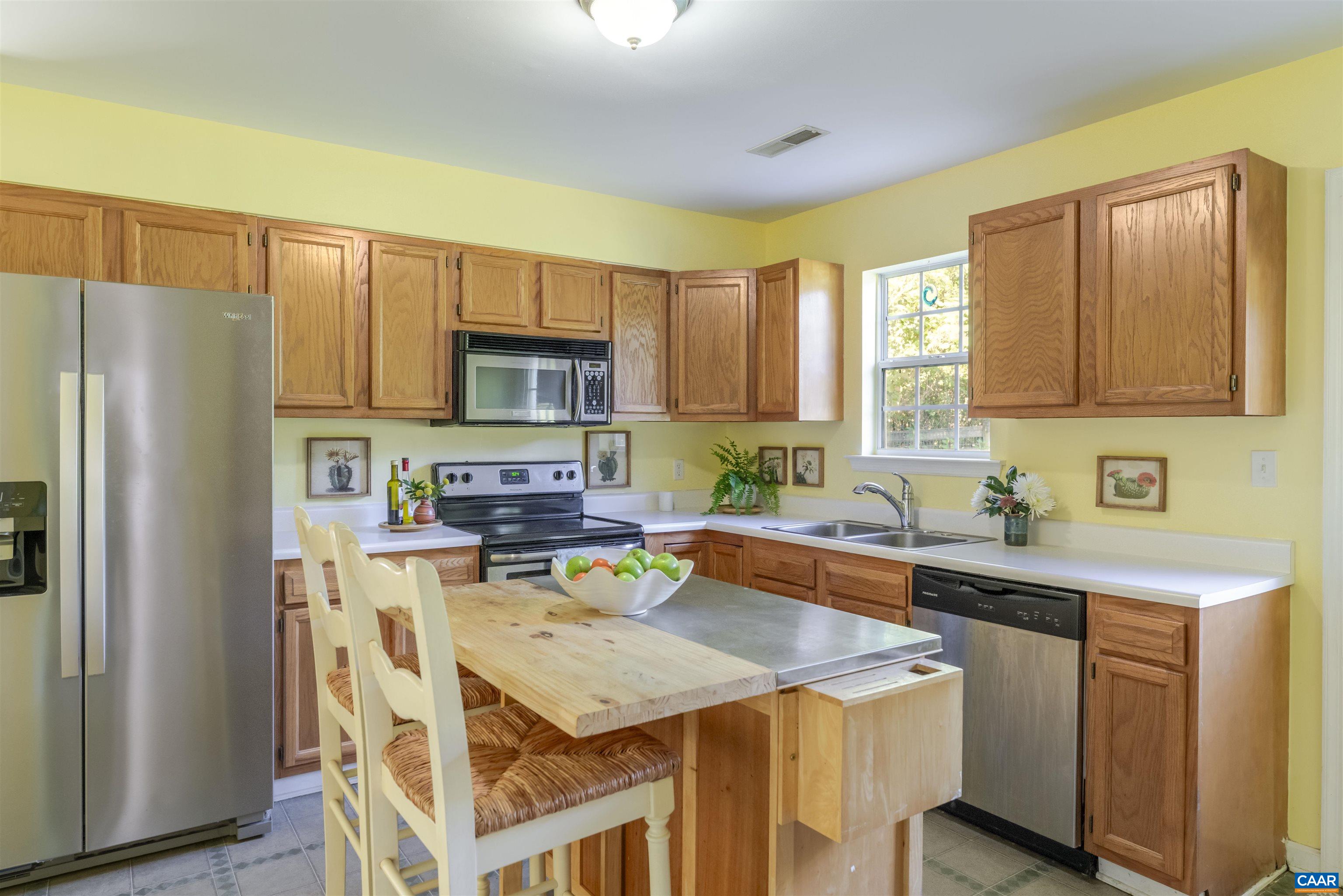 28 Bernice Lane Ruckersville, VA 22968 - Photo 9 of 40 a kitchen with a sink a stove a refrigerator cabinets and a center island