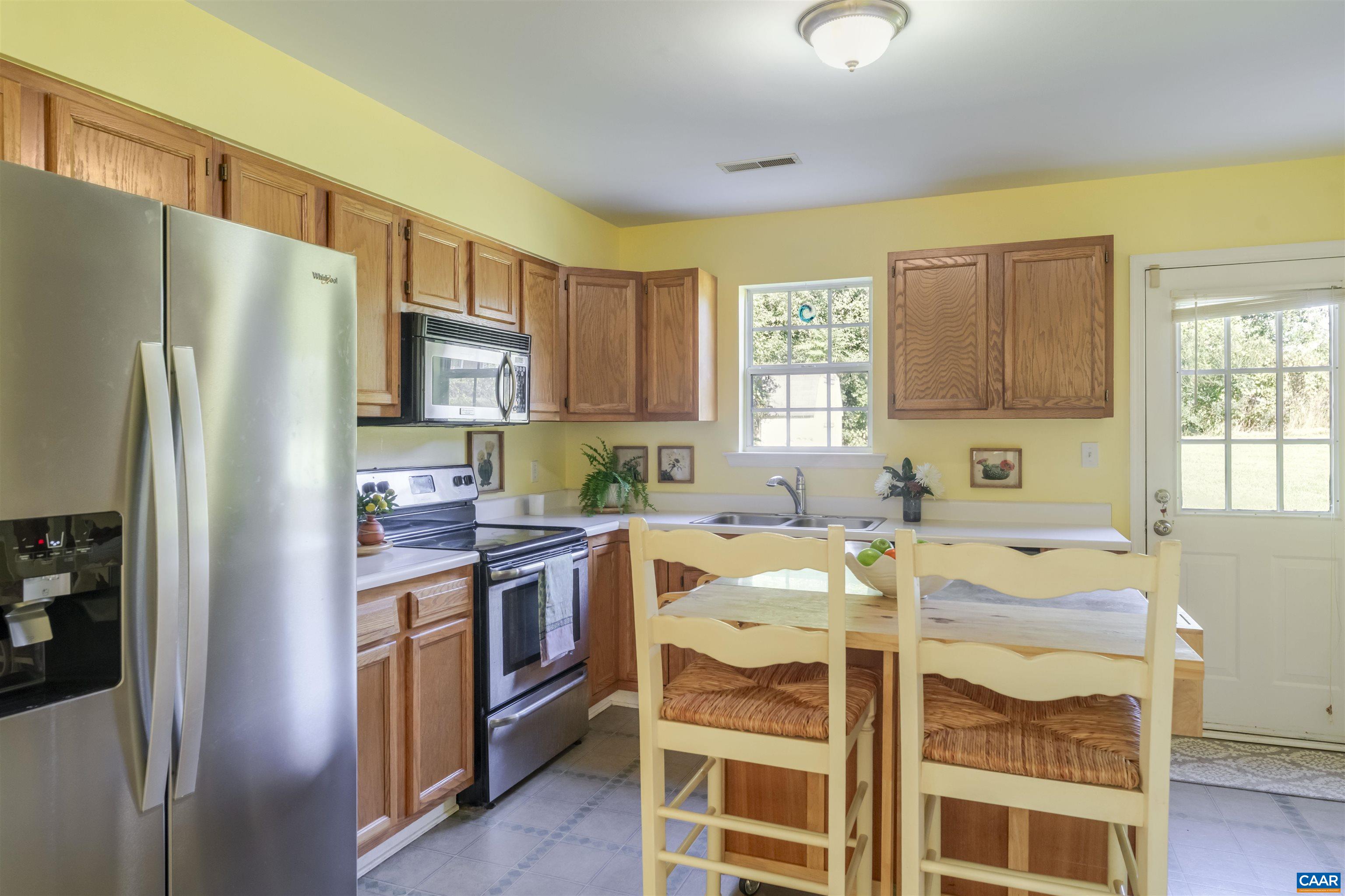 28 Bernice Lane Ruckersville, VA 22968 - Photo 10 of 40 a kitchen with stainless steel appliances granite countertop a refrigerator a stove a sink dishwasher and white cabinets with wooden floor
