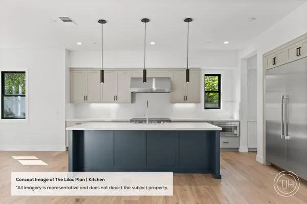 a kitchen with kitchen island a sink stainless steel appliances and cabinets